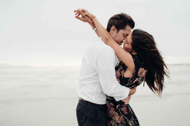 man and woman hugging each other near body of water